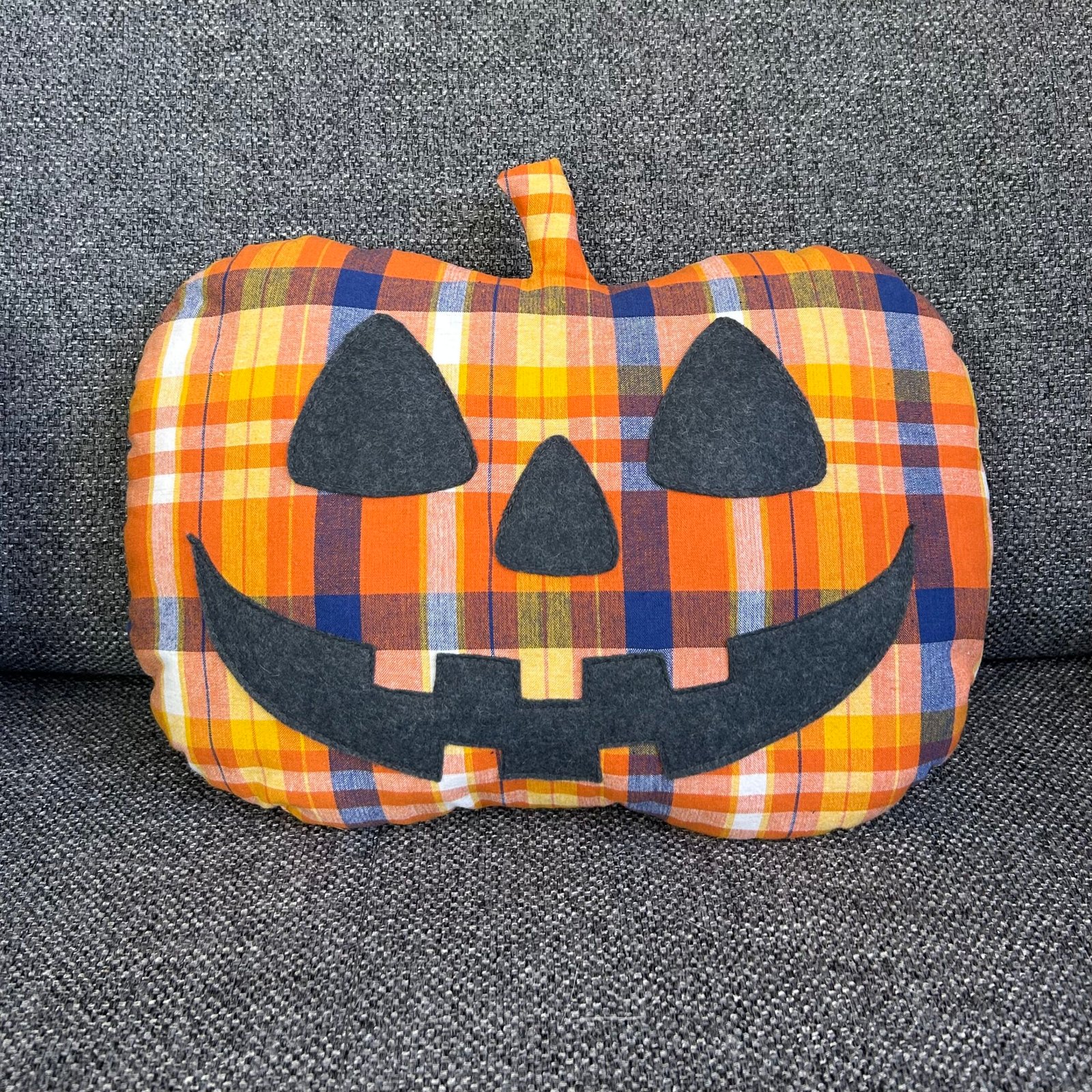 Premier modèle de coussin citrouille en tissu avec son visage amusant en feutrine